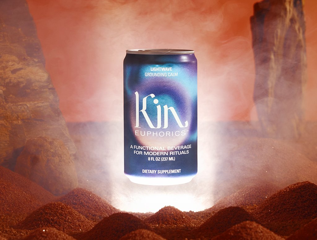 Can of kin euphorics calming non-alcoholic functional beverage, lightwave, made to wind down. Can is floating above a sandy desert backdrop