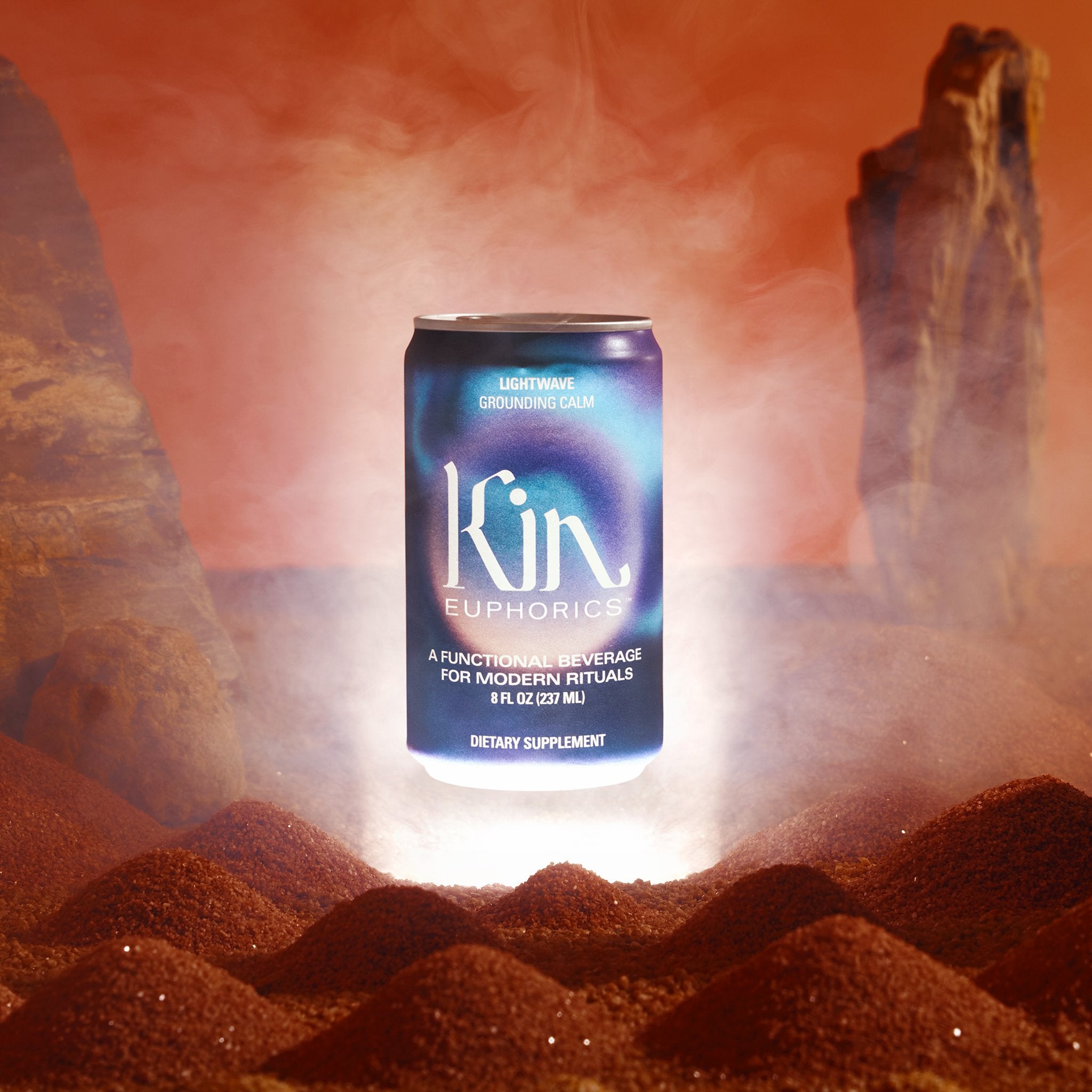 Can of kin euphorics calming non-alcoholic functional beverage, lightwave, made to wind down. Can is floating above a sandy desert backdrop