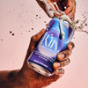 Hand cracking open a can of kin euphorics calming alcohol replacement beverage, lightwave. There is liquid spritzing from the can Thumb