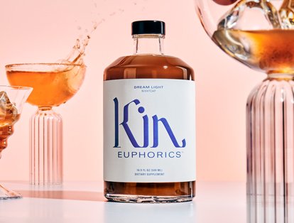 a bottle of ​​kin euphorics dream light with glasses filled with ice and garnish